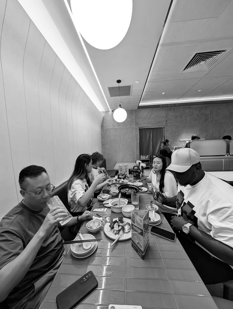 Harold at a long table with the team after an event
