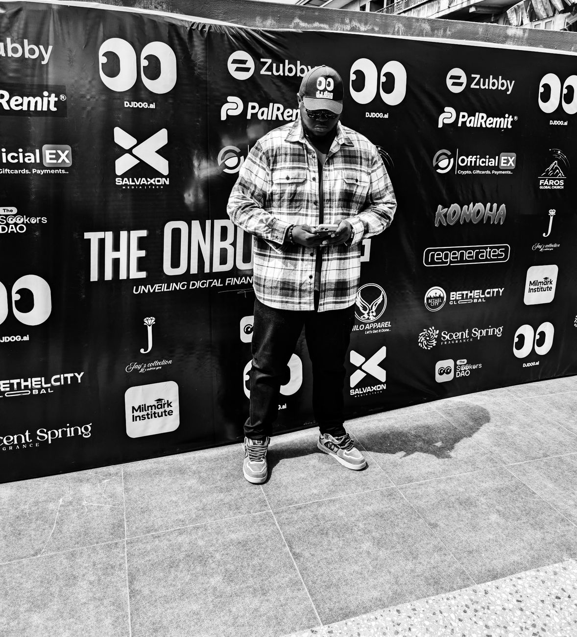 Harold in front of The Onboard event sponsor wall