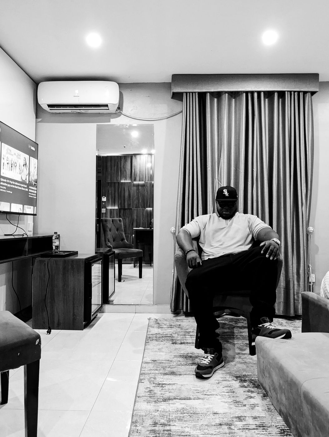 Harold in 2025, seated in an armchair in a hotel suite